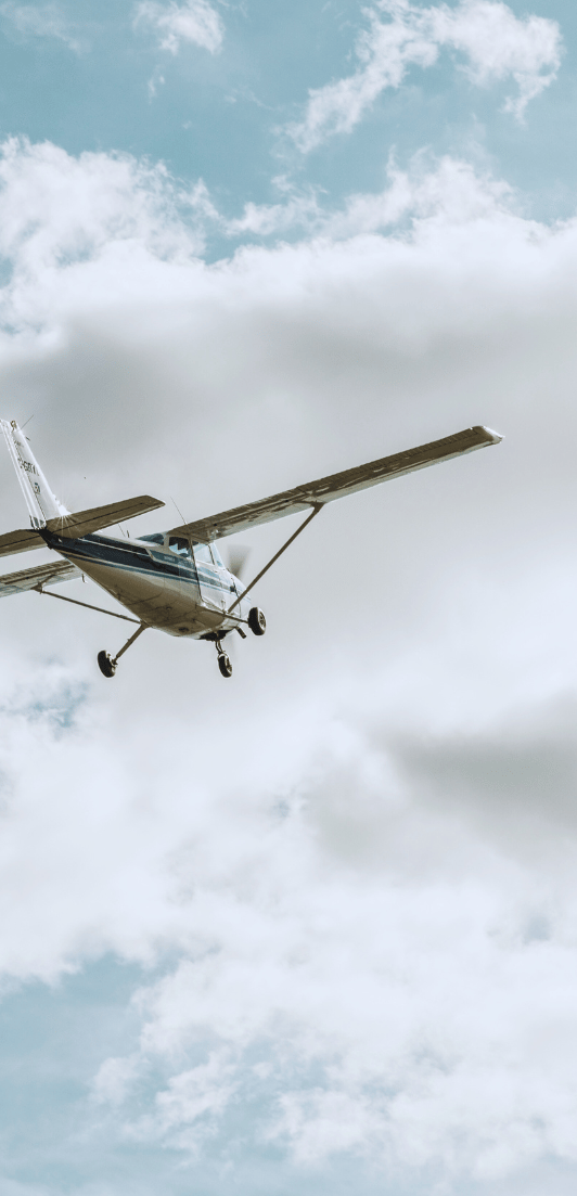 A Cessna 172 flying through the clouds.